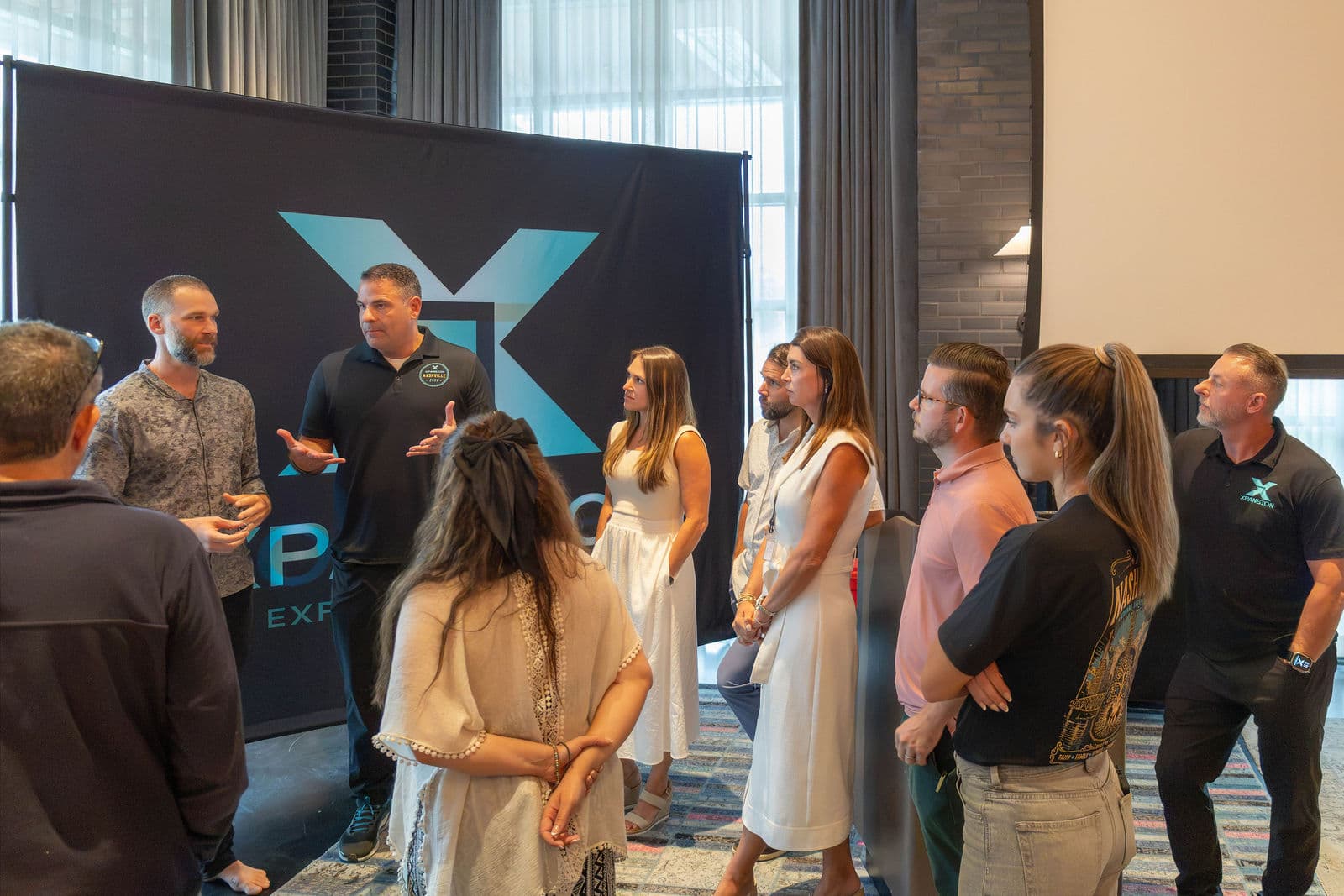 Three founders with attendees in engaged conversation