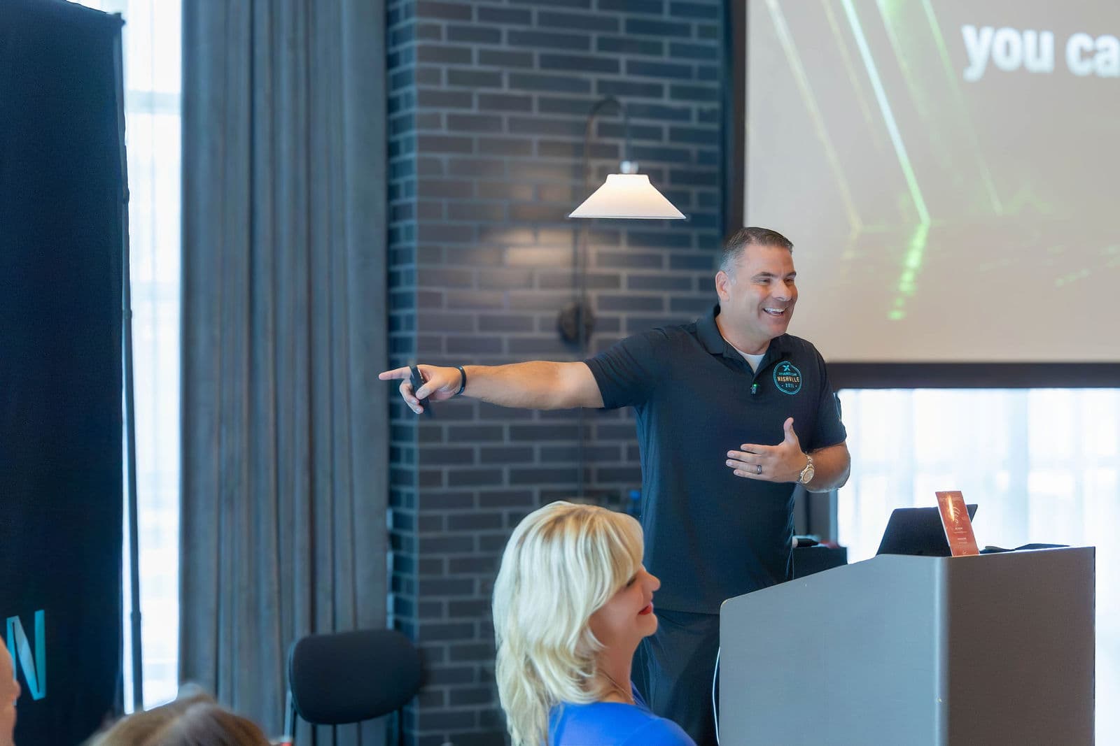 Spencer on stage pointing energetically at the audience