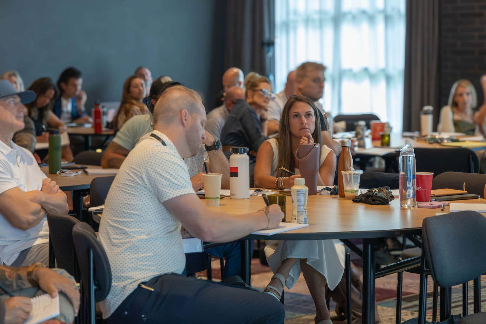 Attendees focused and working at their tables